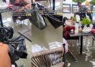Customers lift their legs while dining as flood water takes over restaurant in Lagos (video)